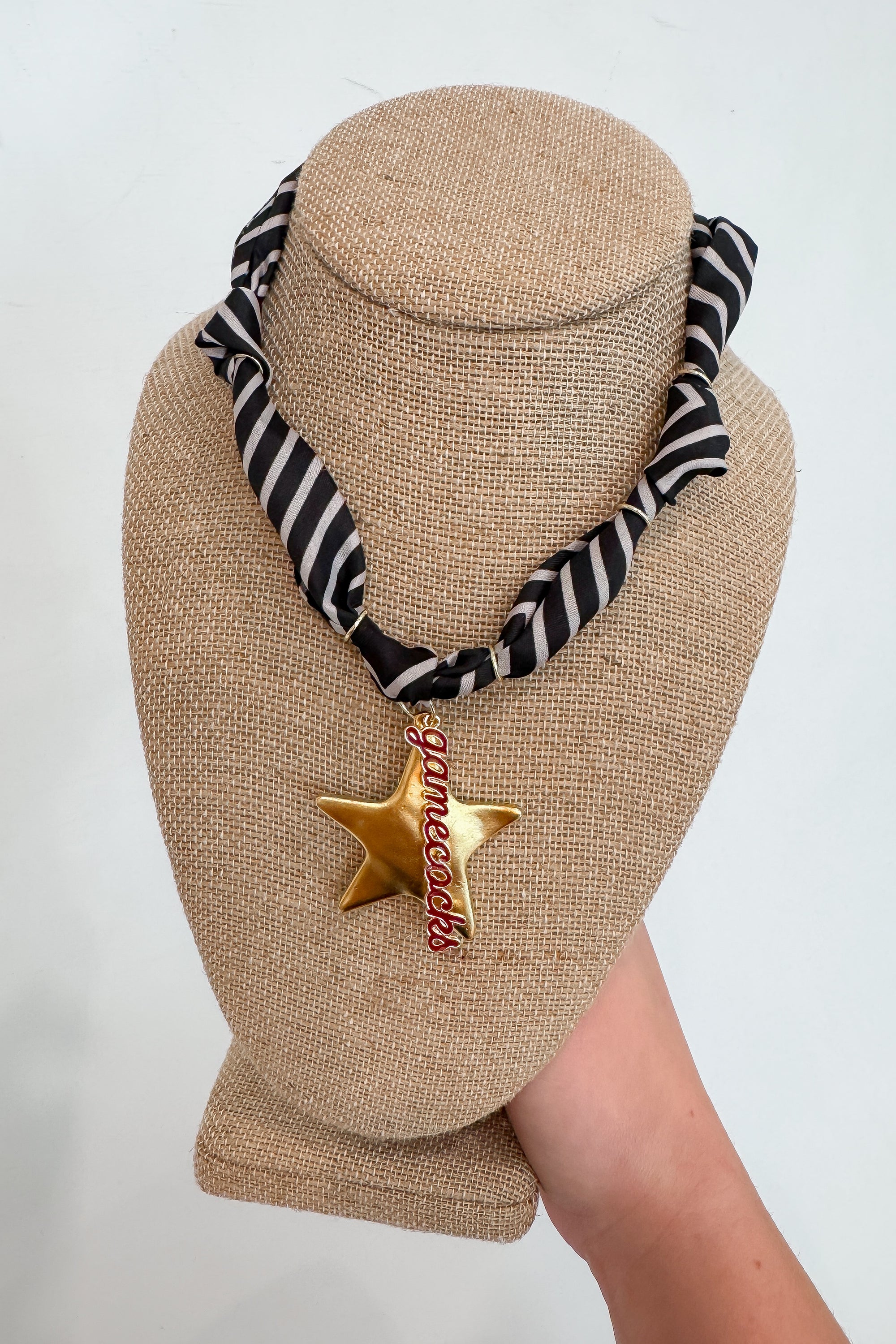 USC Gamecock Scarf Necklace with black and white striped bandana and gold star charm featuring red 'Gamecocks' text, ideal for game day wear.
