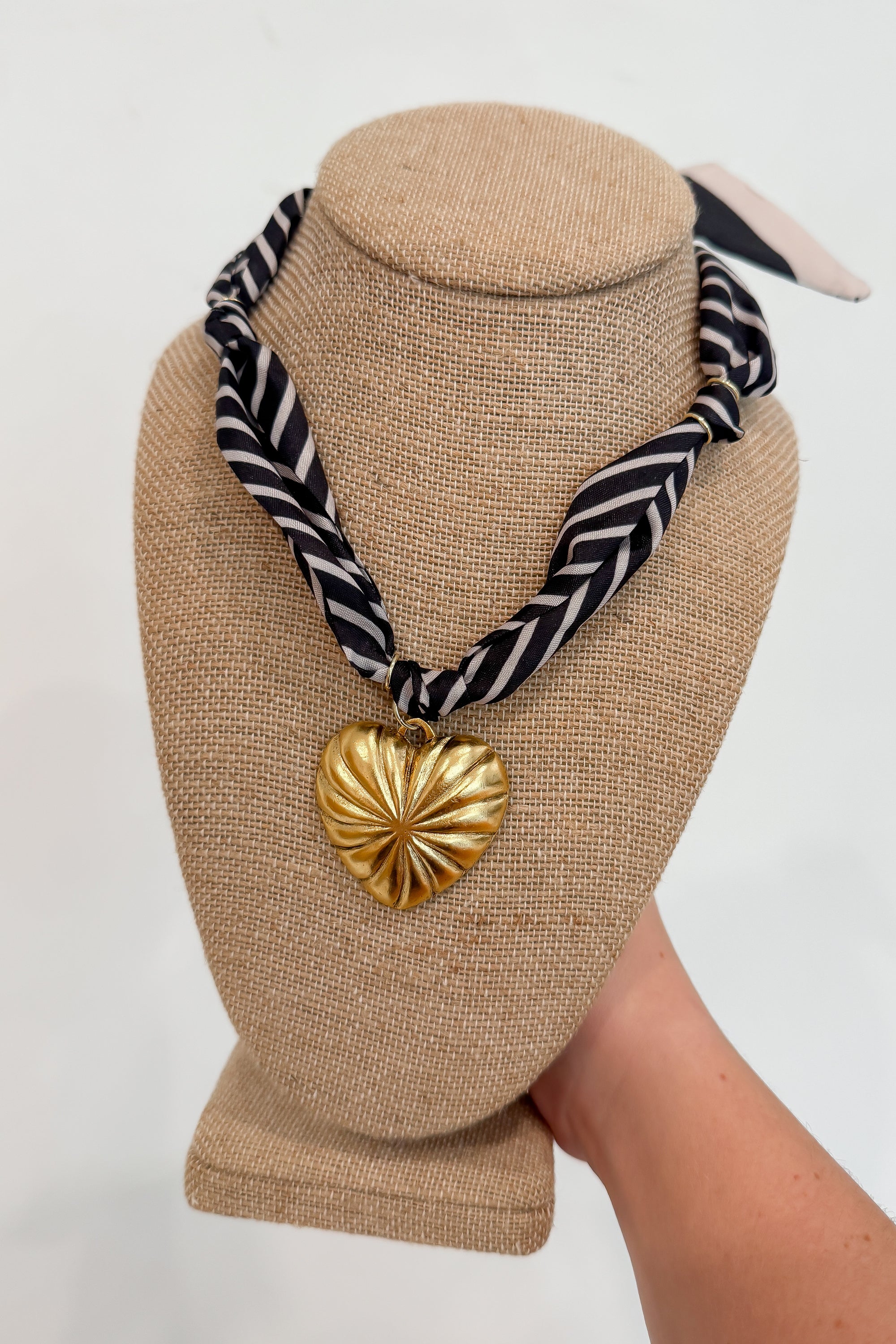 Heart Bandana Necklace with black and white striped scarf and gold heart pendant, chic adjustable jewelry from L. Mae Boutique.