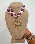 Garnet USC Gamecock Serafina Scarf Necklace from L. Mae Boutique featuring a gold medallion with Gamecock emblem on a floral garnet and white scarf.