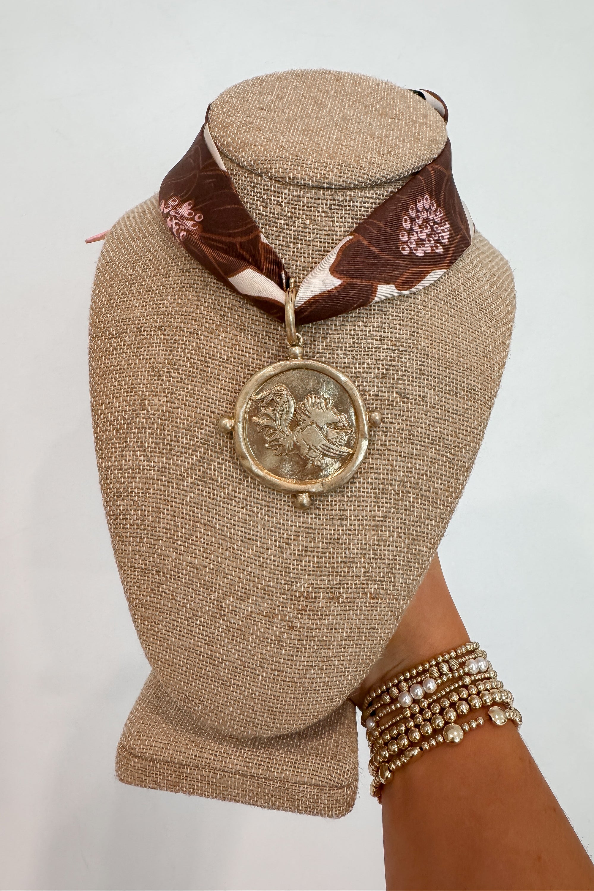 Neutral Moon USC Gamecock Bandana Necklace featuring a mauve floral scarf and bold gold Gamecock pendant, perfect for gameday jewelry styling.