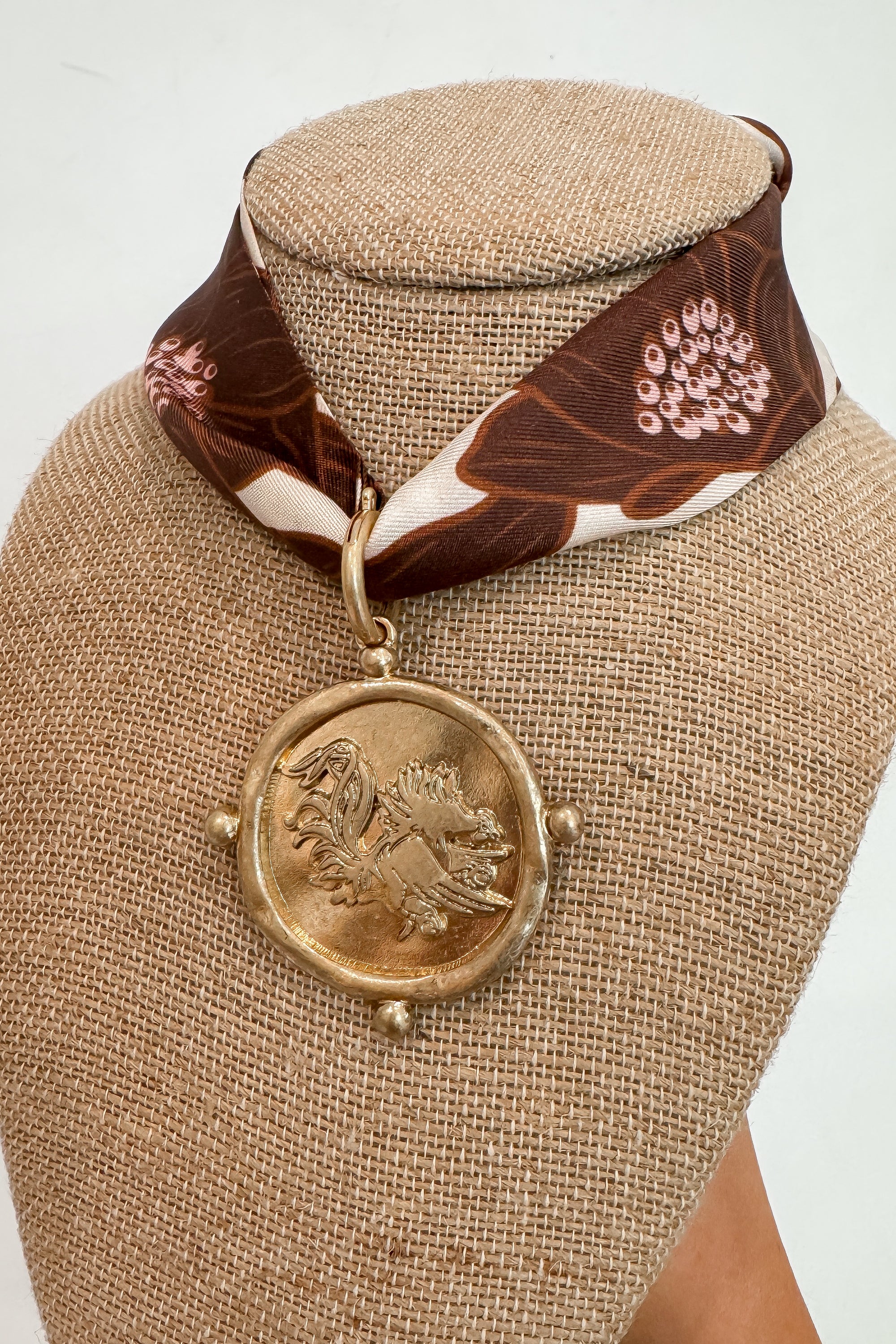 Close-up of Neutral Moon USC Gamecock Scarf Necklace with detailed gold Gamecock pendant and floral bandana, ideal for USC fan accessories.
