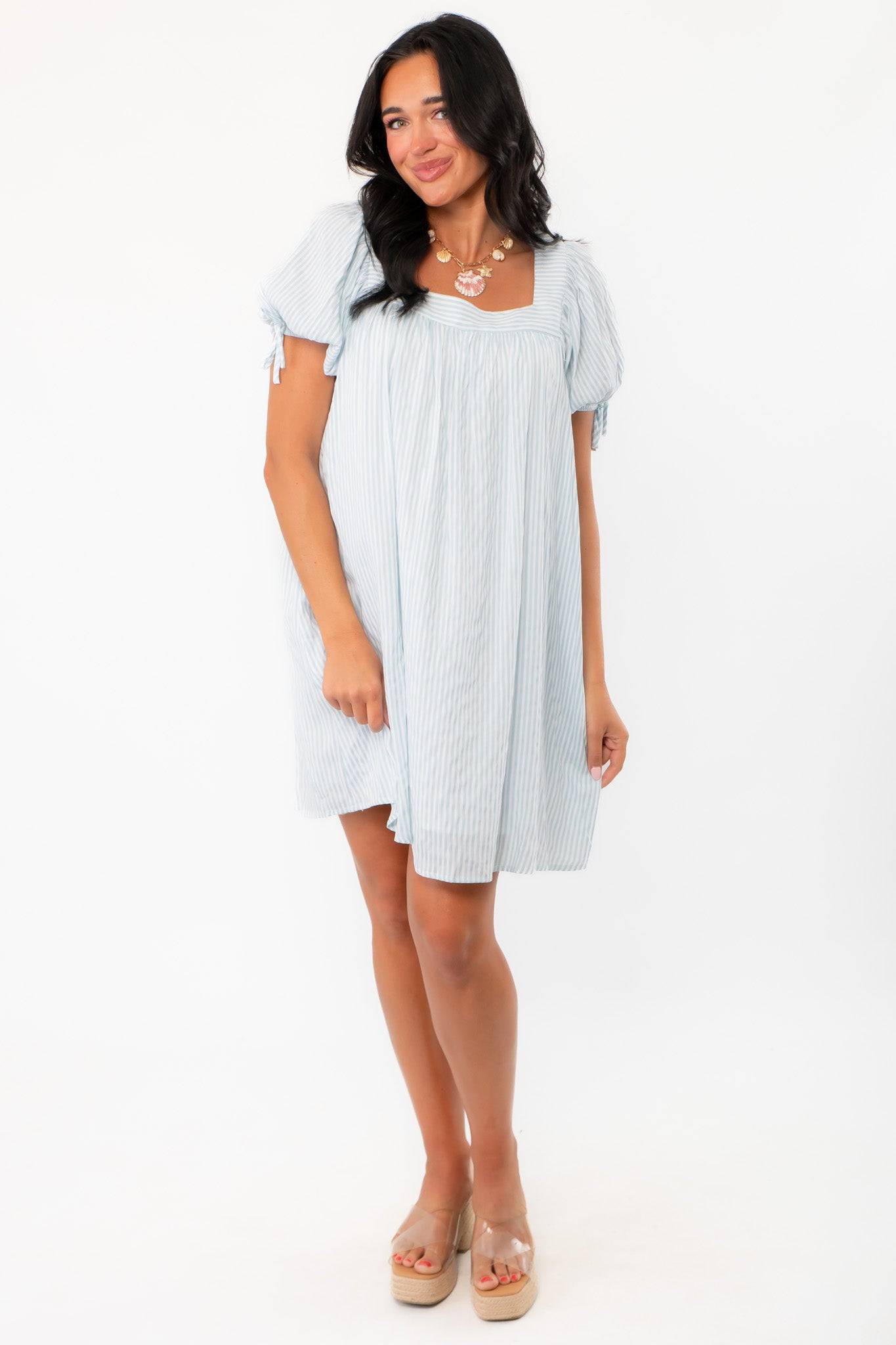 Callie Square Neck Blue Stripe Mini Dress in a flowy silhouette with subtle vertical stripes, great for casual daywear or vacation style.