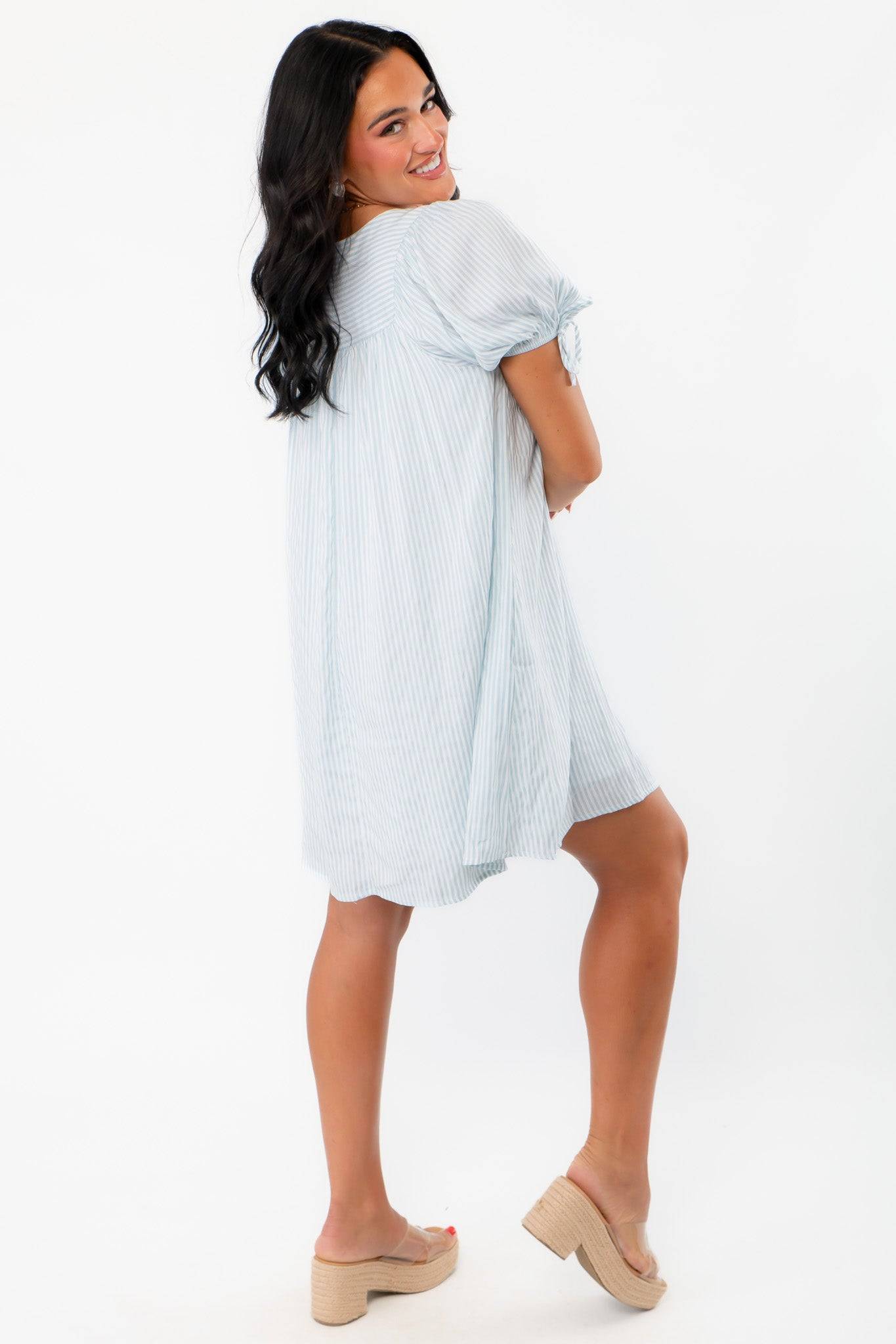 Back view of Callie Square Neck Blue Stripe Mini Dress showing its airy fit and lightweight fabric, perfect for summer comfort and style.