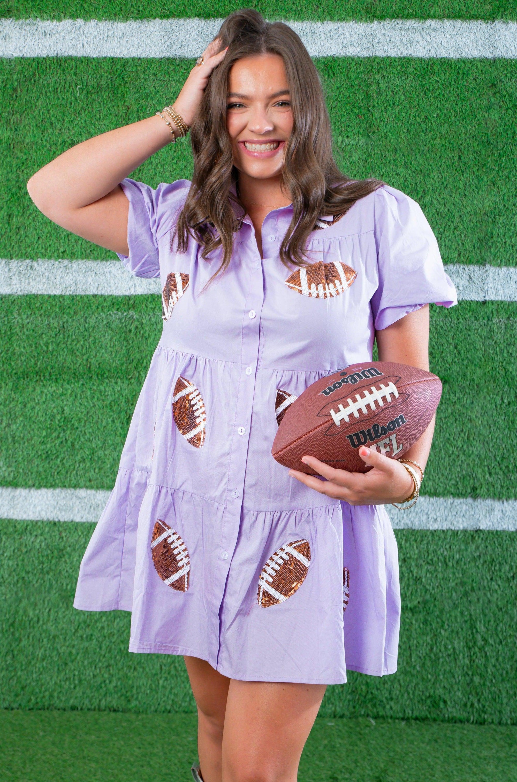 Model holding football in Lavender Sequin Football Dress - Trendsetting Gameday Style with glittery football patches and flared silhouette for sporty flair.