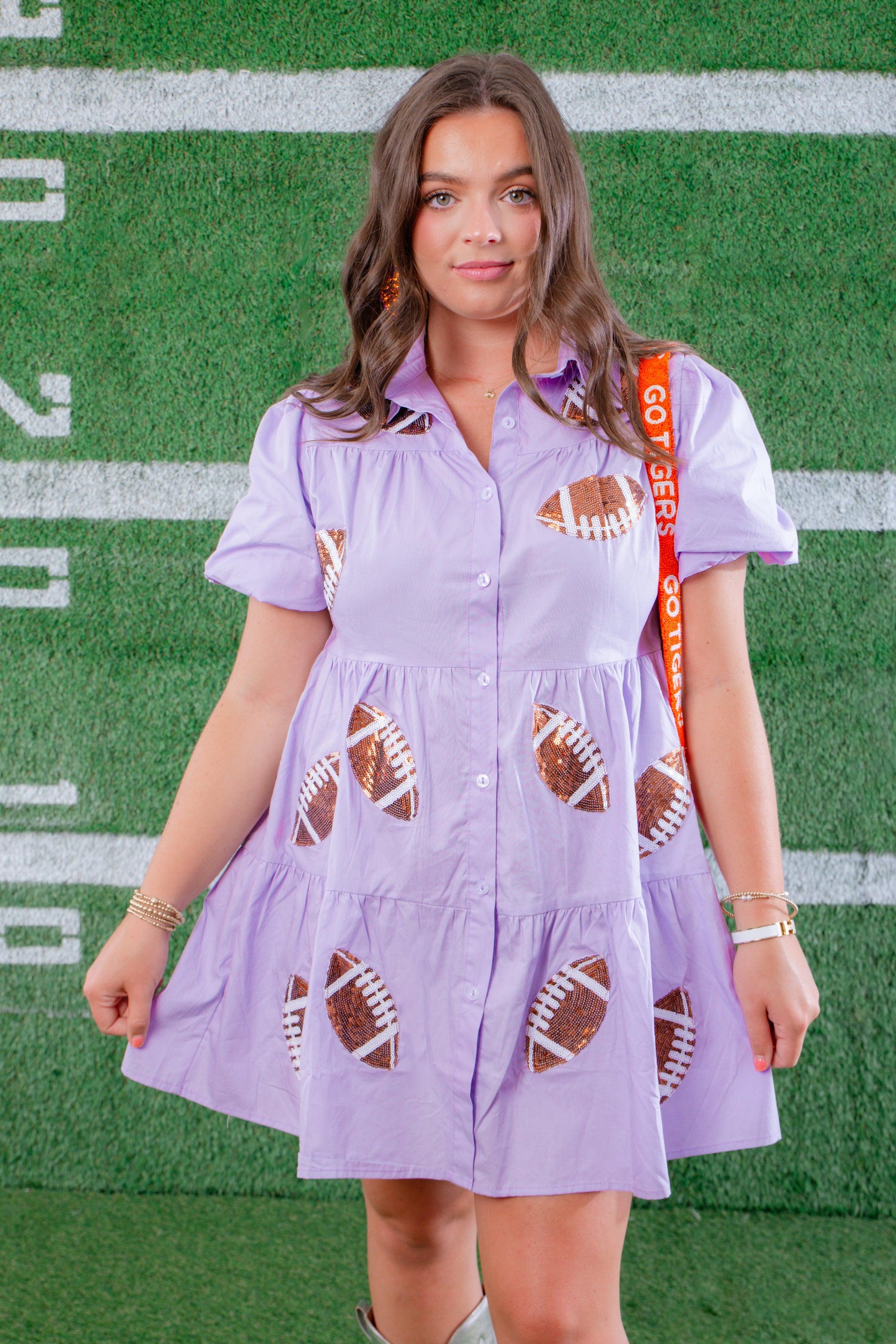 Lavender Sequin Football Dress - Trendsetting Gameday Style styled with gameday accessories, featuring sequin footballs and a relaxed fit for festive events.
