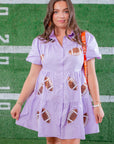 Lavender Sequin Football Dress - Trendsetting Gameday Style styled with gameday accessories, featuring sequin footballs and a relaxed fit for festive events.