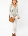 Chic Liza Mint Cable Knit Cardigan styled with neutral pants and a woven bag. A versatile and timeless layering piece for effortless fashion.