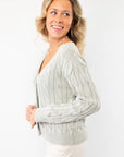Side view of Liza Mint Cable Knit Cardigan showcasing its relaxed fit and intricate cable knit pattern. A must-have pastel sweater for layering.