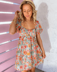 Effortless summer style with the MINKPINK Lorelei Hibiscus Flower Ruched Mini Dress, showcasing a charming hibiscus print and a breezy, feminine silhouette.
