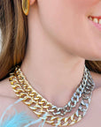 Model wearing Mia Gold-Plated Bean Stud Earrings, showcasing their 1.2-inch sleek oval drop design. A stylish accessory for day-to-night glam.