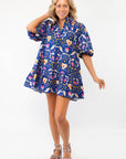 Model wearing the Morgan Folk Love Mini Dress with a flattering babydoll silhouette, collared neckline, and puff sleeves for a trendy outfit.
