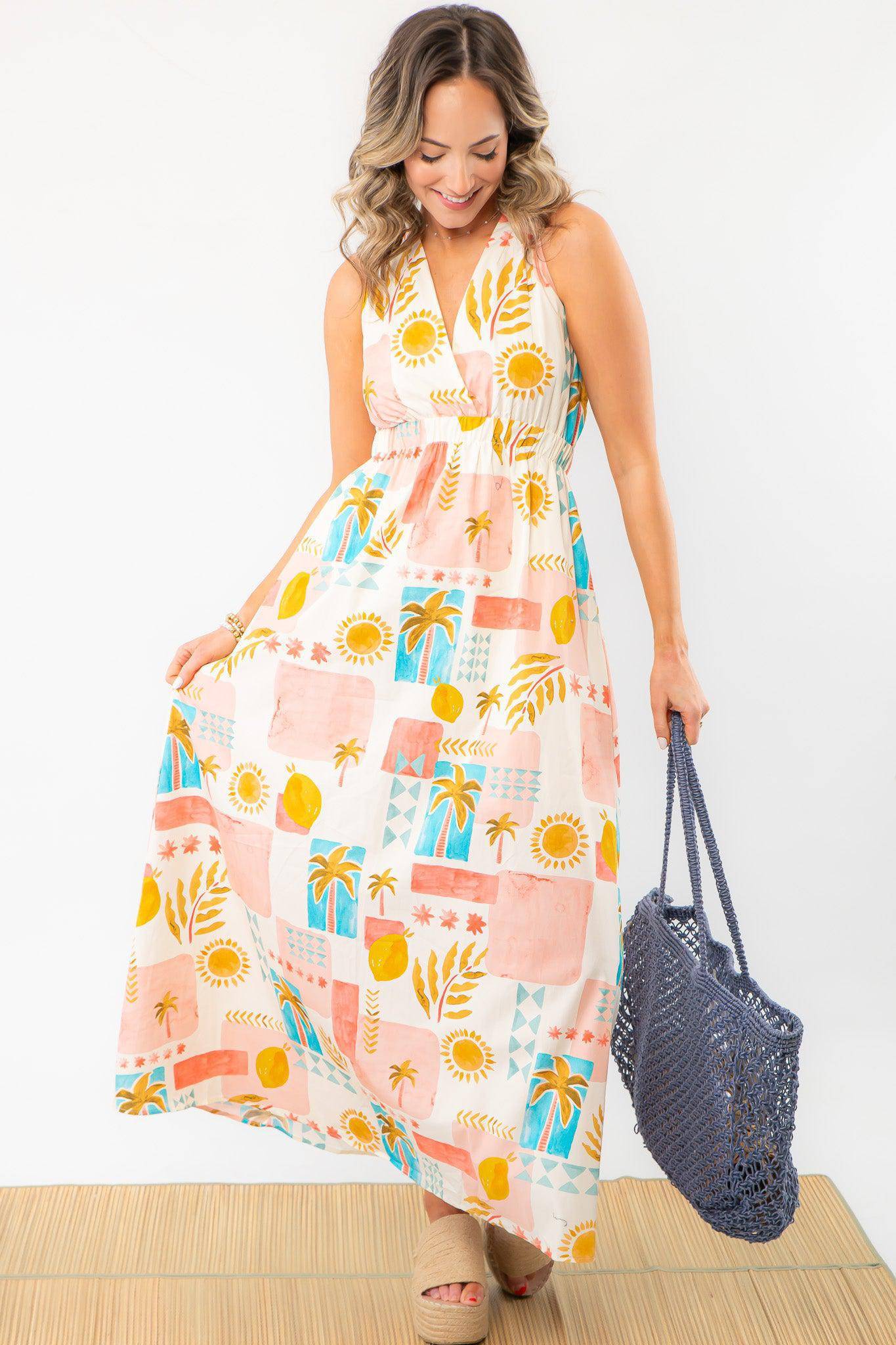Flowy Moroccan Coast Tile Print V-Neck Maxi Dress styled with a woven tote, featuring a breezy fit and vibrant summer-inspired patterns.
