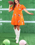 Show off your team spirit in the Orange Sequin Football Dress, a vibrant short dress with football-themed sequins and a tiered silhouette.