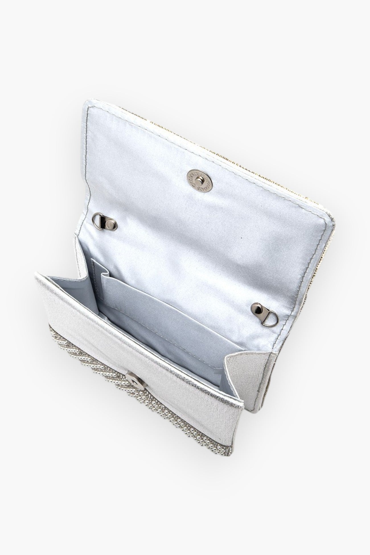 Interior view of the pearl studded rhinestone handle clutch bag, displaying its spacious compartments and snap closure for secure storage.