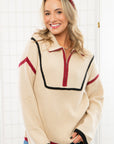 Close-up of the garnet and black Quarter Zip Sweater featuring contrast piping and ribbed knit texture. A versatile and stylish layering piece.