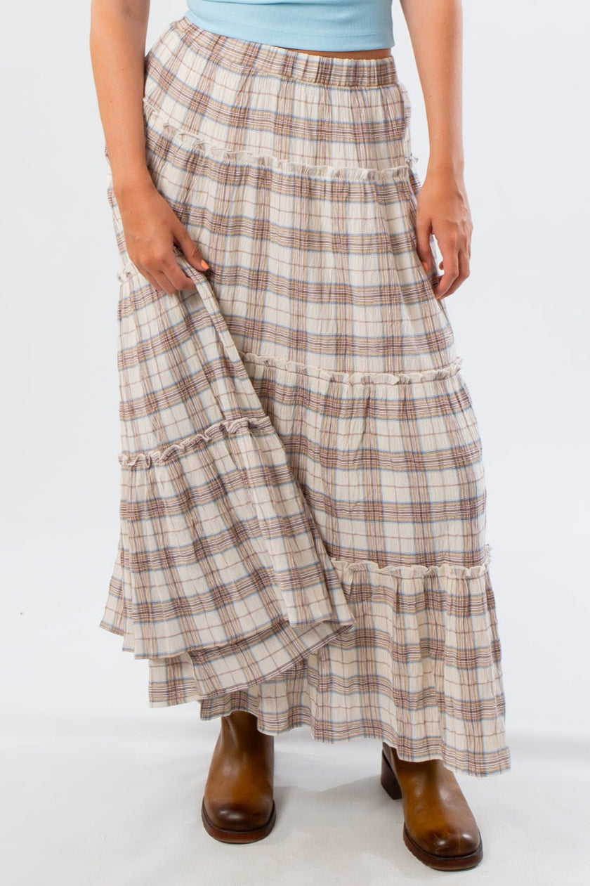 Close-up of Brown Plaid Maxi Skirt - Fort Worth featuring tiered ruffle design and soft plaid fabric, ideal for autumn outfits.