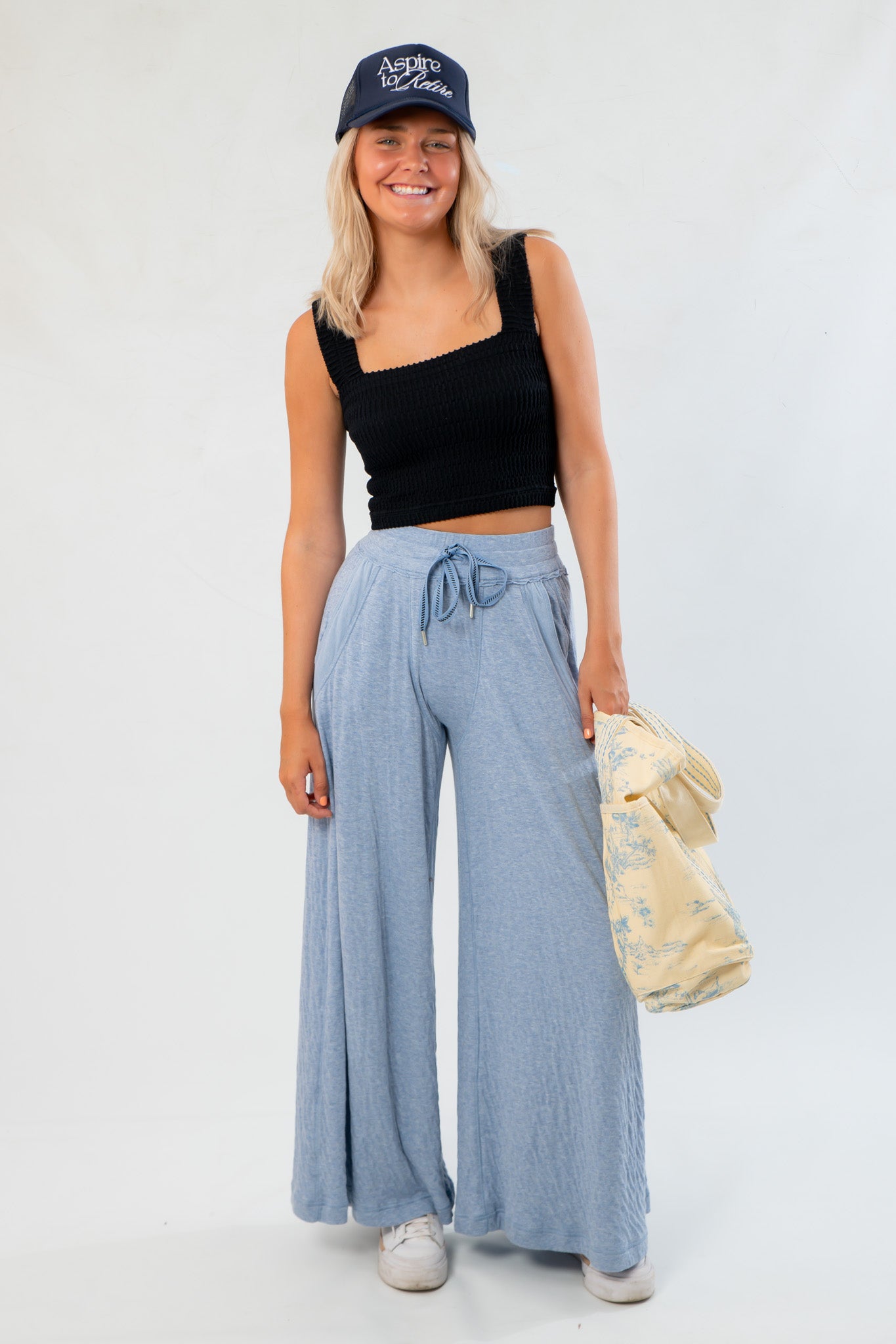 Model wearing Free People Soft Chambray Wide-Leg Lounge Pants paired with casual top and accessories, showcasing relaxed loungewear style.