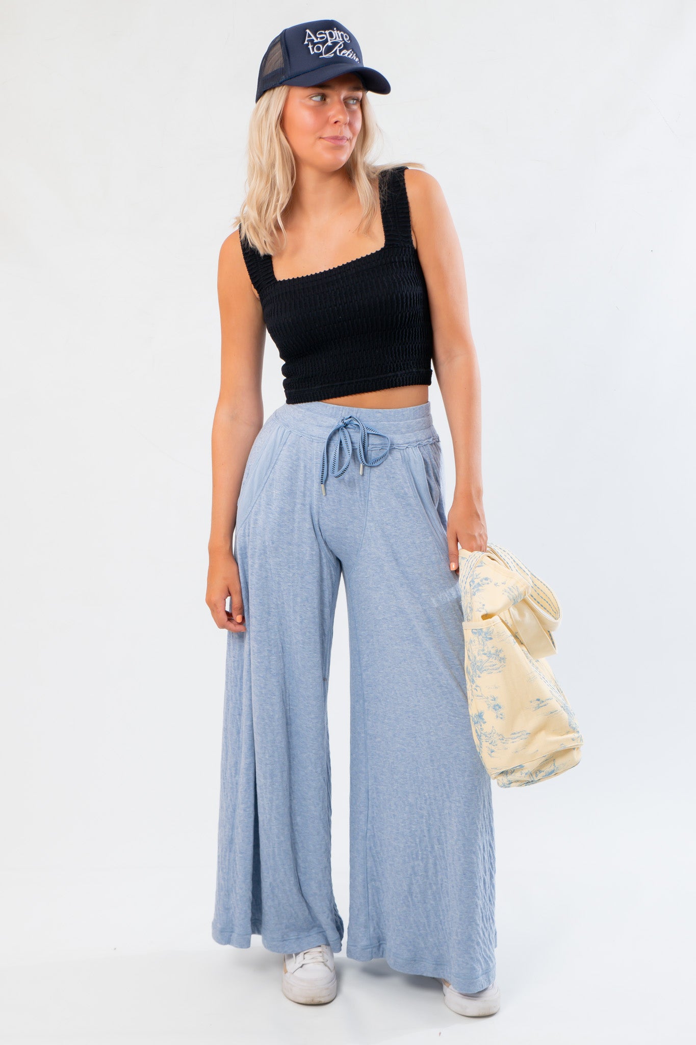 Free People Soft Chambray Wide-Leg Lounge Pants in light blue with high-rise fit, drawstring waist, and side pockets styled with a black crop top.
