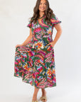 THML Printed Puff Sleeve Tiered Maxi Dress in green with vibrant floral print, featuring puff sleeves and a flowy tiered midi silhouette.