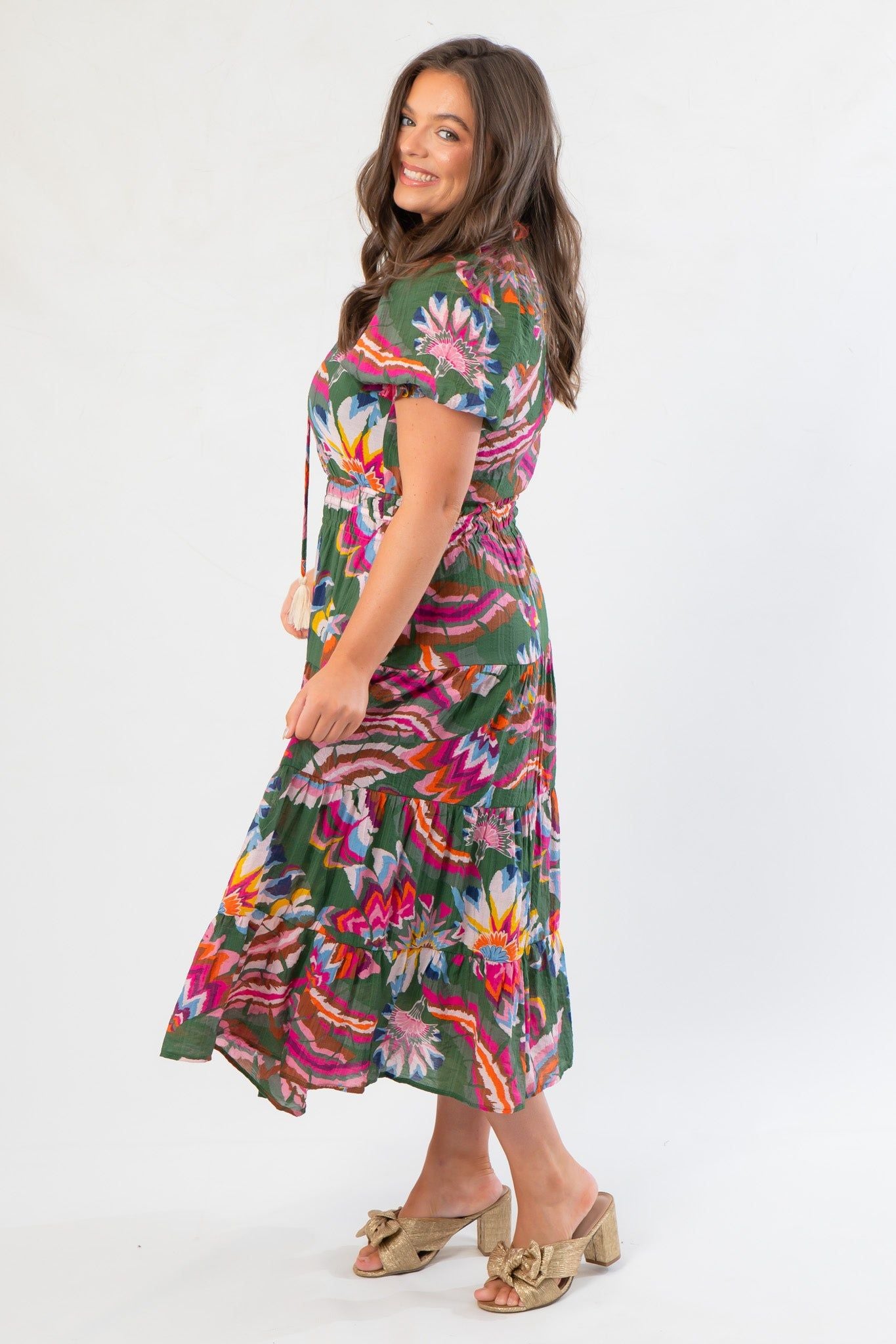 Side view of THML Printed Puff Sleeve Tiered Maxi Dress – Green Floral Midi Dress with colorful pattern and flattering fit for fall fashion.