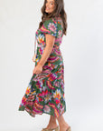 Side view of THML Printed Puff Sleeve Tiered Maxi Dress – Green Floral Midi Dress with colorful pattern and flattering fit for fall fashion.