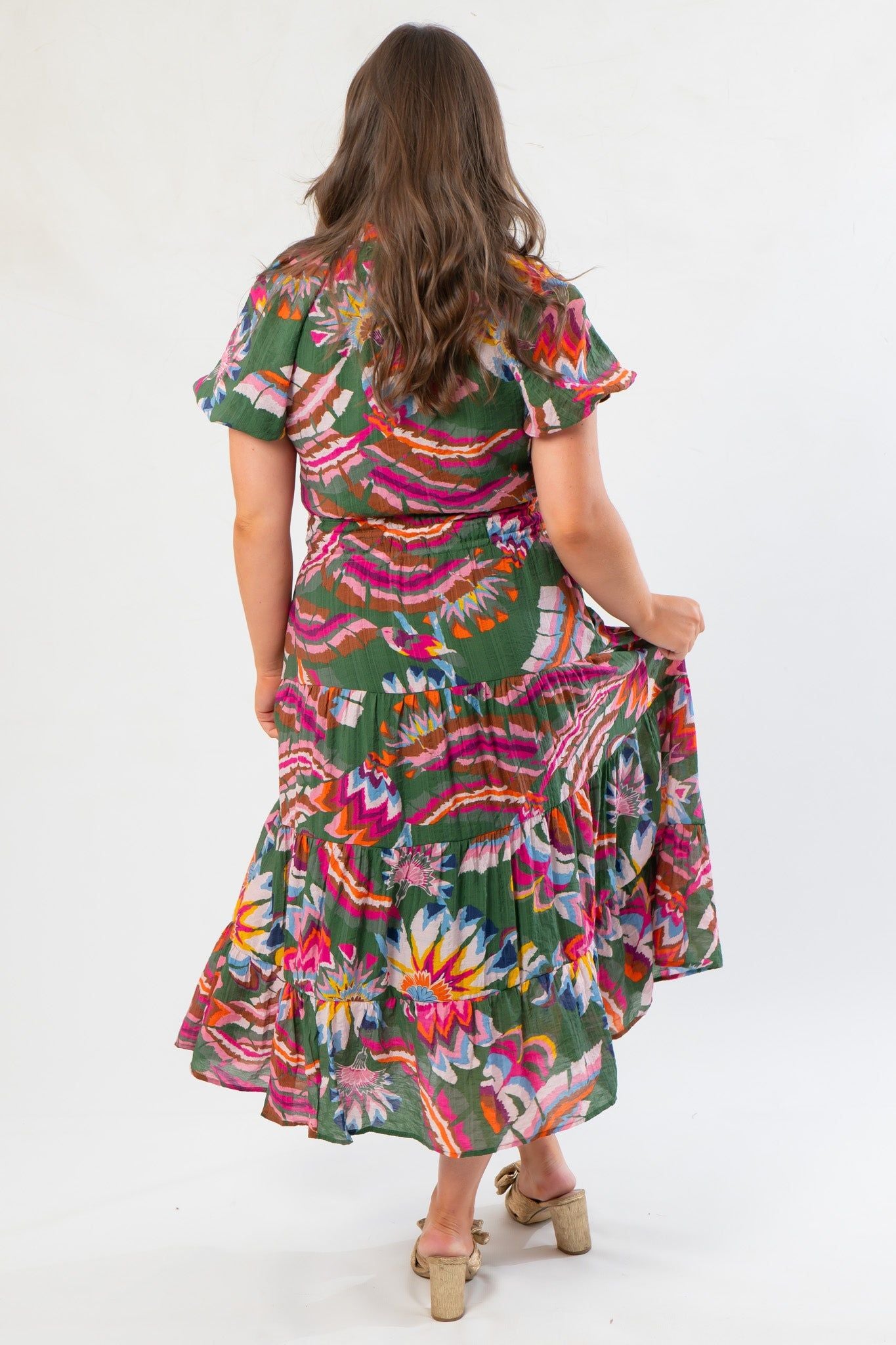 Back view of THML Printed Puff Sleeve Tiered Maxi Dress with tiered skirt and bold floral print, ideal for casual or event wear.