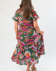 Back view of THML Printed Puff Sleeve Tiered Maxi Dress with tiered skirt and bold floral print, ideal for casual or event wear.