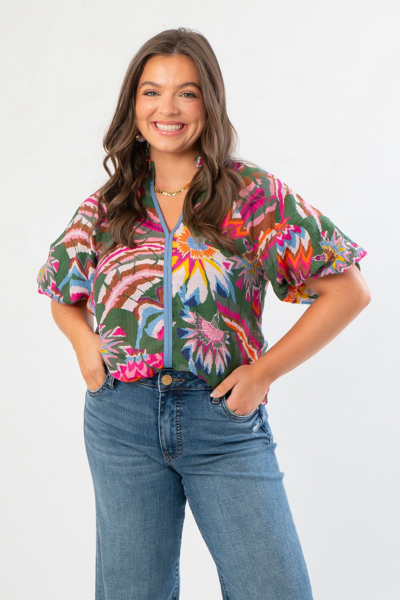 THML Printed Puff Sleeve V-Neck Top in green floral print with short puff sleeves and relaxed fit, styled with high-waisted jeans. Ideal for casual wear.