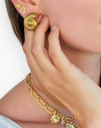 Model wearing Seashell Swirl Gold-Plated Earrings, showcasing their elegant ribbed shell design. A perfect accessory for a beach-inspired look.