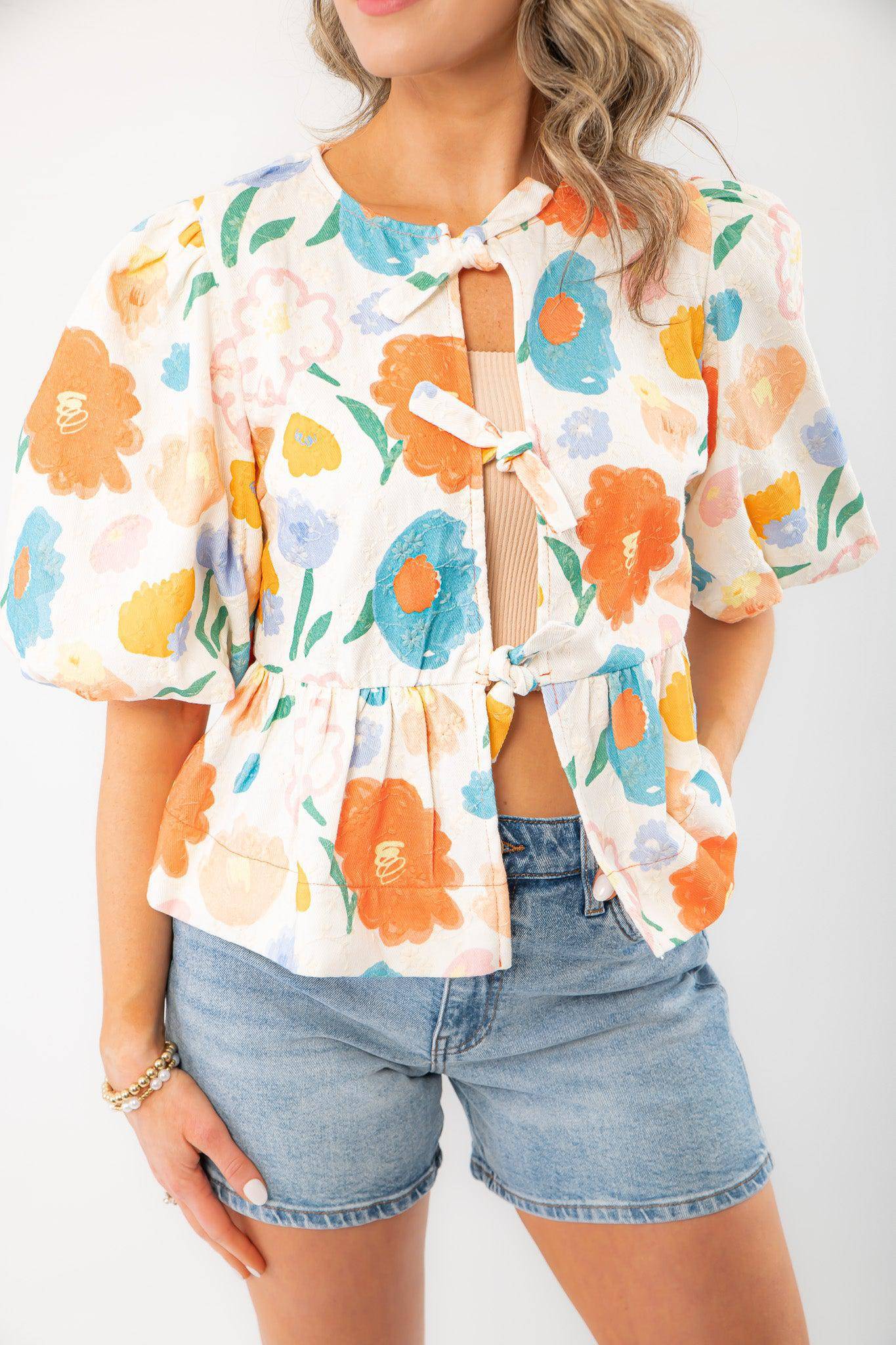 Close-up of the Spring Floral Tie-Front Top featuring a vibrant floral print, tie-front closure, and textured cotton fabric for a stylish spring outfit.