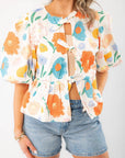 Close-up of the Spring Floral Tie-Front Top featuring a vibrant floral print, tie-front closure, and textured cotton fabric for a stylish spring outfit.