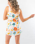 Back view of the Spring Multi-Floral Mini Dress highlighting its sleeveless cut, scoop back, and vibrant floral print for a stylish spring look.