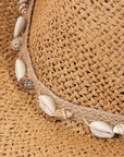 Close-up of the Coastal Vibes Puka Shell Straw Cowboy Hat showcasing intricate woven straw details and decorative puka shell accents.