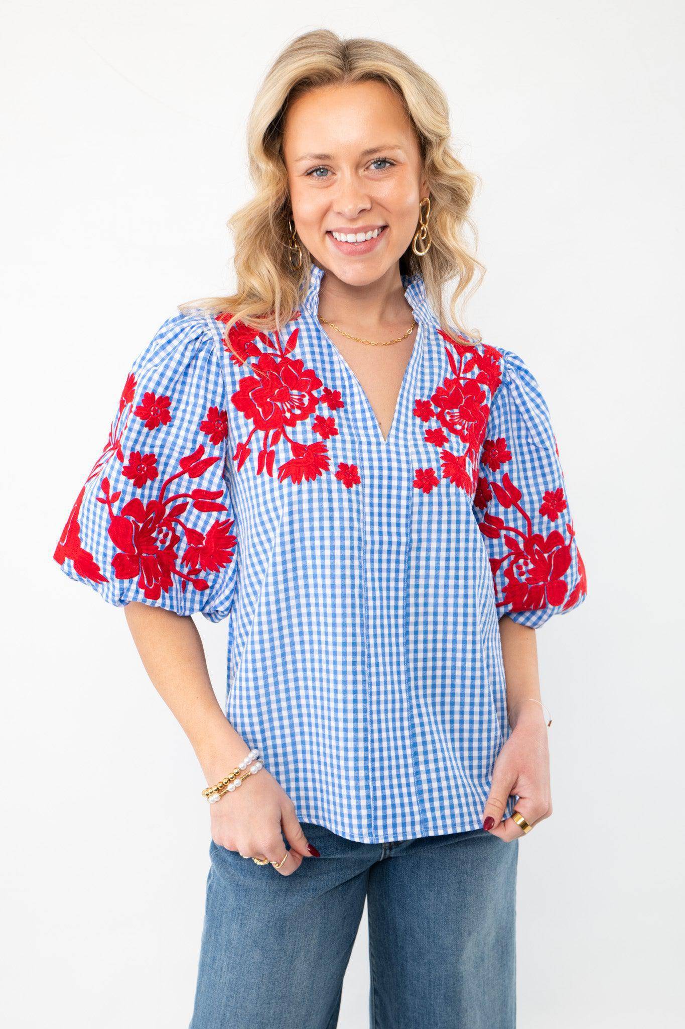 THML Blue Gingham Embroidered Top LM with red floral embroidery on puff sleeves, featuring a V-neckline and short sleeves, styled with denim jeans.