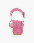 Back view of pink raffia block heel sandals highlighting the textured raffia heel and secure ankle strap for stylish support.