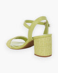 Back angle of green raffia block heel sandals showcasing the textured raffia heel and open-toe design for a breezy summer feel.