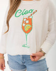 Close-up of Show Me Your Mumu Ciao Cocktail Woodsy Sweater featuring vibrant cocktail glass graphic and textured knit fabric.