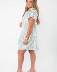 Model wearing Blue Hydrangea Flutter Sleeve Mini Dress with platform sandals, ideal for Easter or bridal shower events.