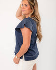 Side view of THML Navy Ruffle Sleeve Top showing flared stitched sleeves and relaxed fit, ideal for warm-weather styling.