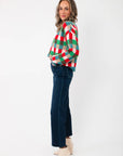 Side view of Holiday Check Knit Sweater in red, green, and blue checks, paired with denim for a casual holiday look.