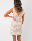 Back view of Champagne Rose Sequin Mini Dress with a deep V-back cut and floral sequin detailing, perfect for festive and bridal events.