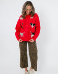 Front view of Lucy Red Dog Button Up Cardigan with whimsical dog designs, ideal for dog lovers seeking a cozy and fun winter cardigan.