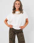 Whatever The Weather Ivory Sleeveless Sweater – Oversized Spring Knit styled with leopard print pants. Lightweight and perfect for layering.