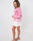 Side view of the Something Sweeter Pink Jacquard Fringe Hem Cardigan showing textured knit and playful fringe hem with soft pink tones.