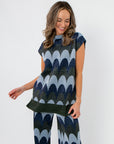 Retro Wave Metallic Knit Sleeveless Sweater in tunic length with blue and green shimmer wave pattern, styled with matching pants.