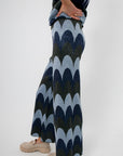 Side view of Retro Wave Metallic Knit Cropped Pant with flared leg and bold blue wave print for a retro-inspired style.