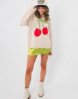 Key Lime Green Silky Shorts - Stylish Comfort Summer Wear paired with a cherry sweater and white boots, ideal for casual summer looks.