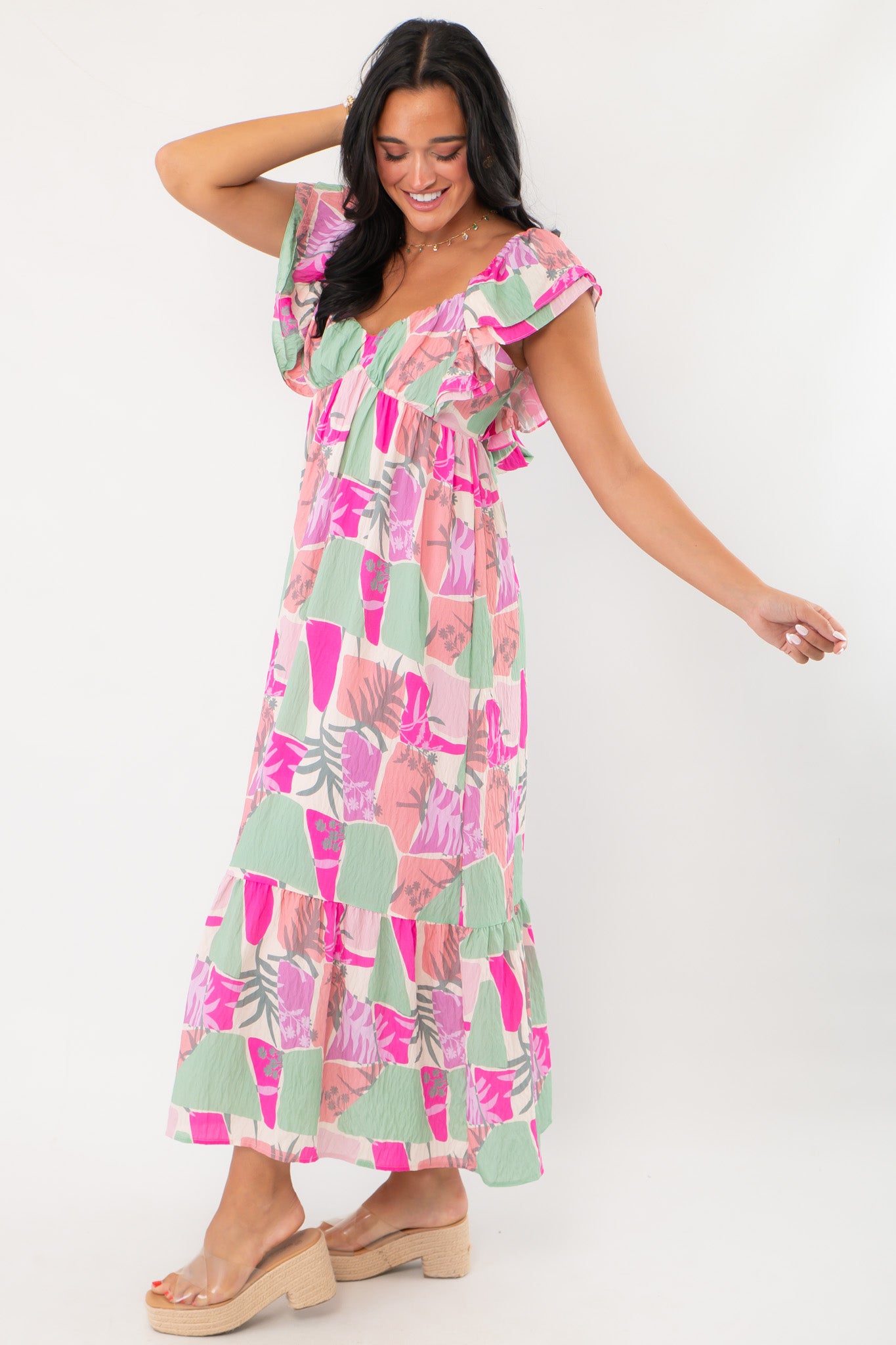 Side view of THML Pink Palm Ruffle Sleeve Maxi Dress in a breezy tiered design, perfect for vacation or wedding guest attire.