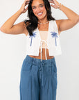 MinkPink Isadora Embroidered Top with blue palm print, sleeveless cropped design, perfect for a boho vacation look.