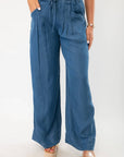 Close-up of Dark Wash Denim Wide Leg Drawstring Pants showcasing pleated front, side pockets, and wide leg silhouette in soft denim fabric.